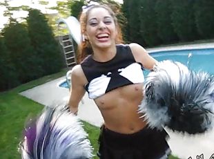 A cute cheerleader flashes her tits while in her uniform