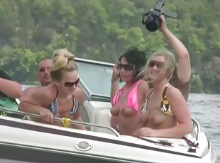 Nasty amateur girls sitting in a boat flash their boobs