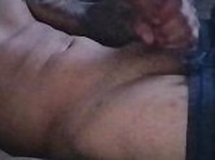 Tattooed Latino striking his thick cock