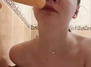 A teenager teaches her friend how to suck in the bathroom