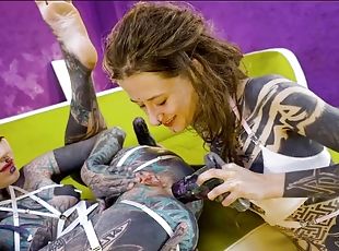 Tattooed hotties fuck each other with crazy toys