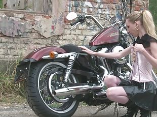 Cute teen is amazed by a big bike