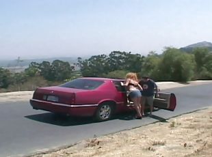 Hitchhiking redhead gets double teamed in a roadside creek